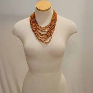 Beaded necklace with wooden clasp closure
